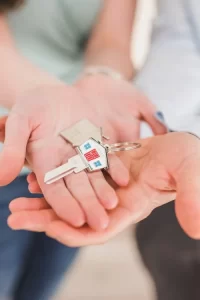 inheritance and estate management - people holding a house shaped key